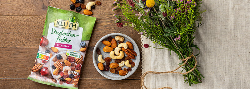 Picture with a Trail-Mix bag and a plate with nuts